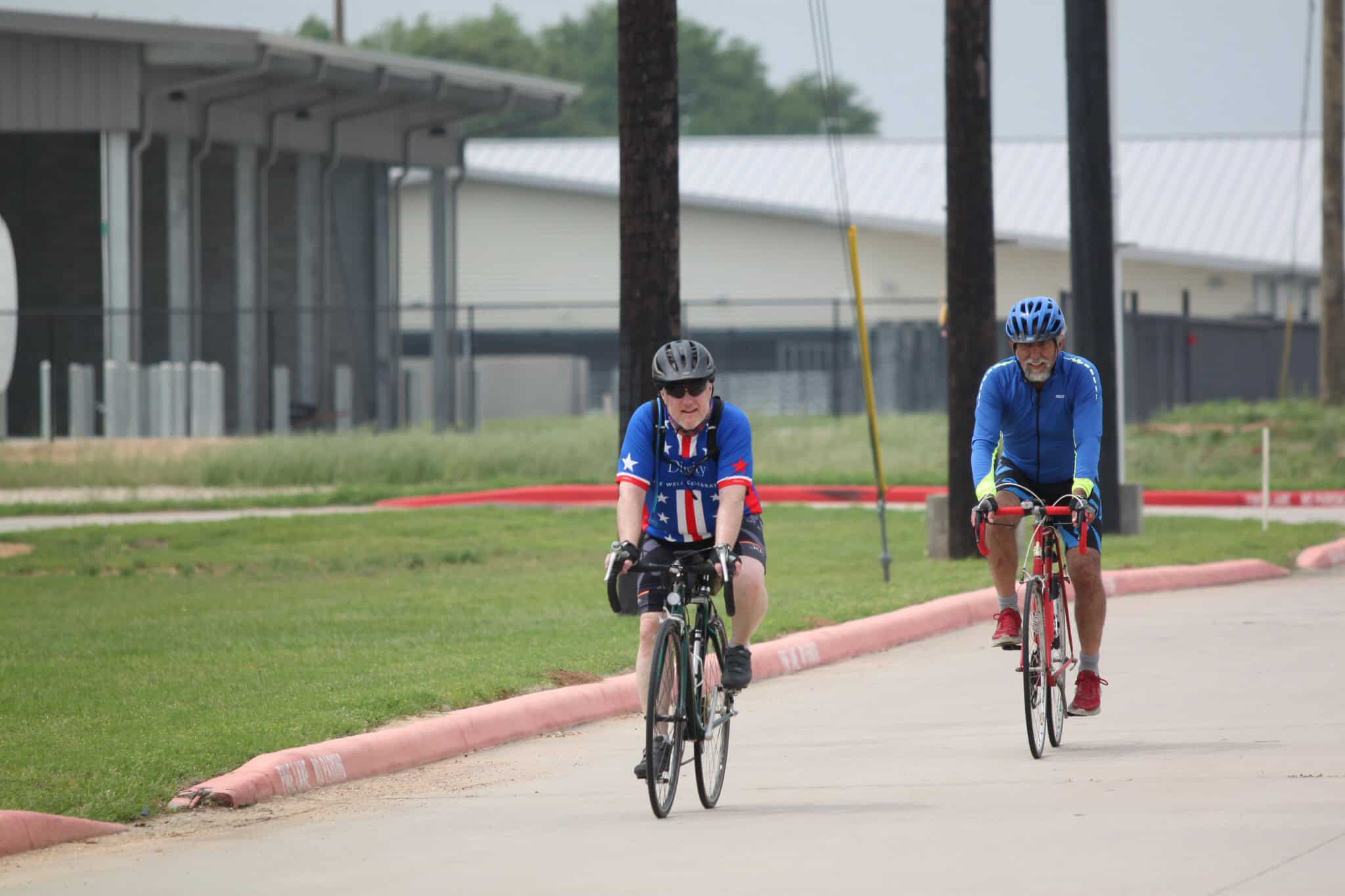 Older men riding bicycles outdoors in casual bike gear, enjoying cycling activity, Bluebonnet Express.