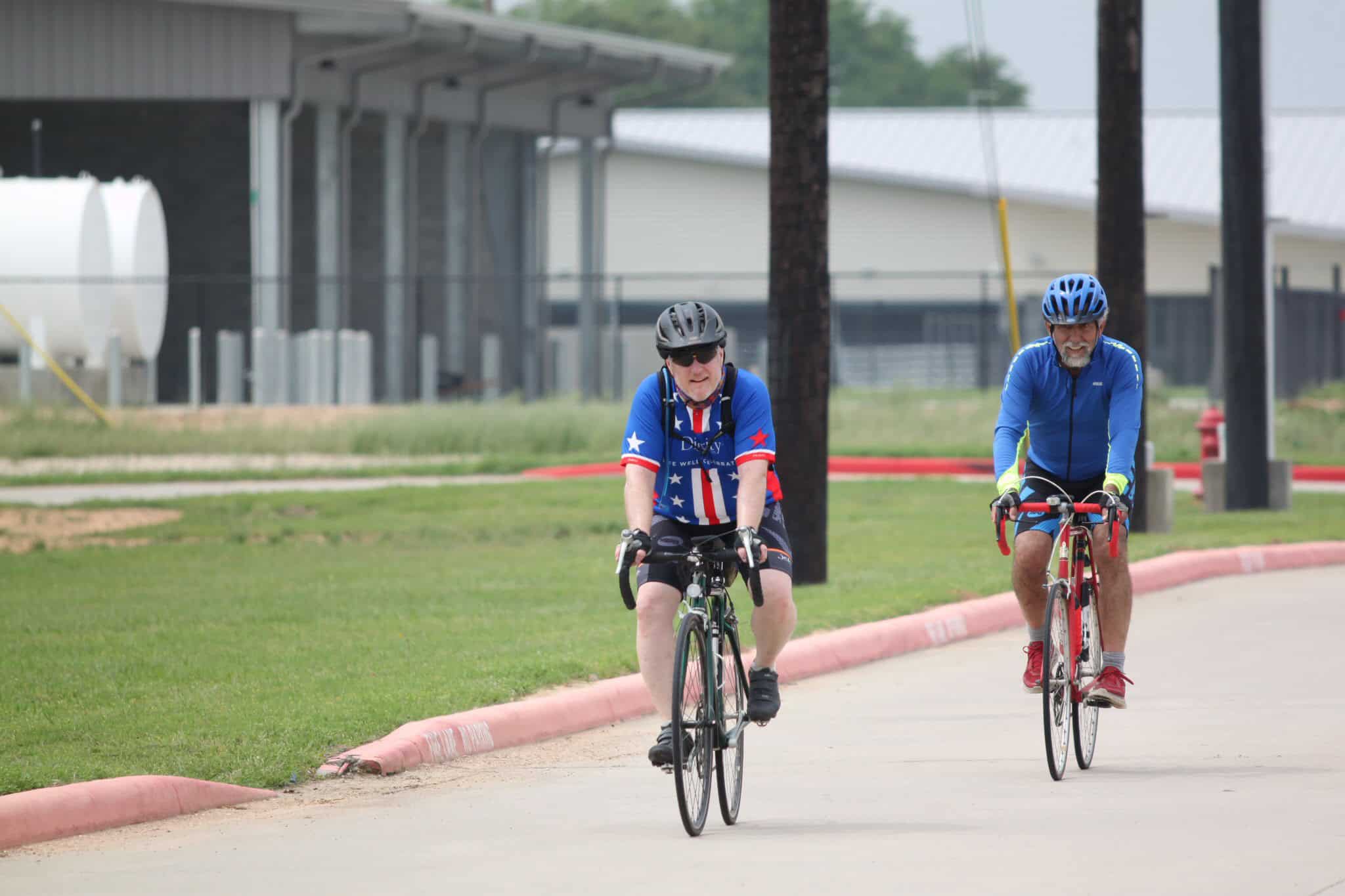 Men riding bicycles outdoors on a sunny day, promoting Bluebonnet Express cycling service.