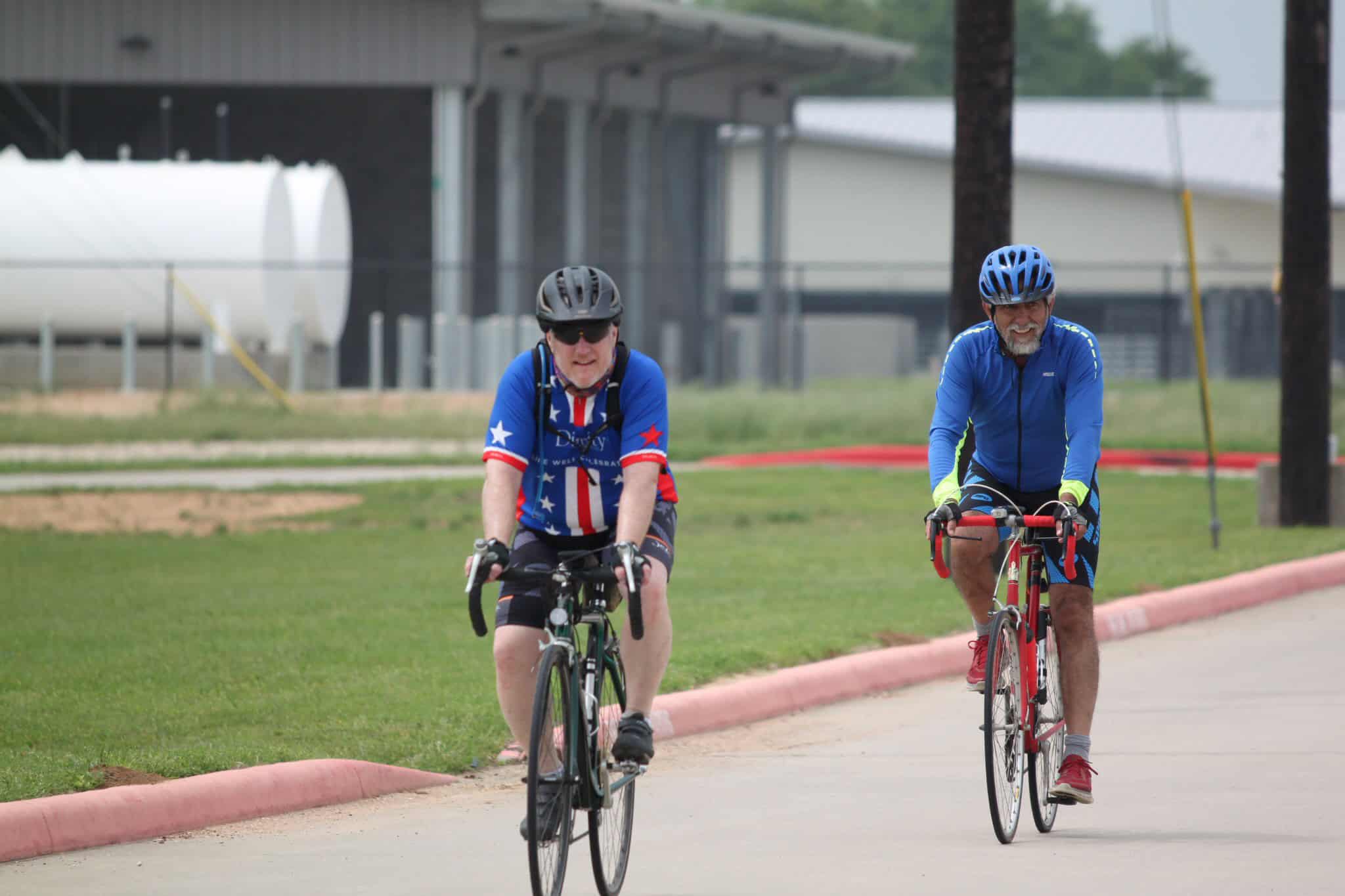 Comfortable seniors cycling on a scenic route, enjoying outdoor recreation with Bluebonnet Express bikes.