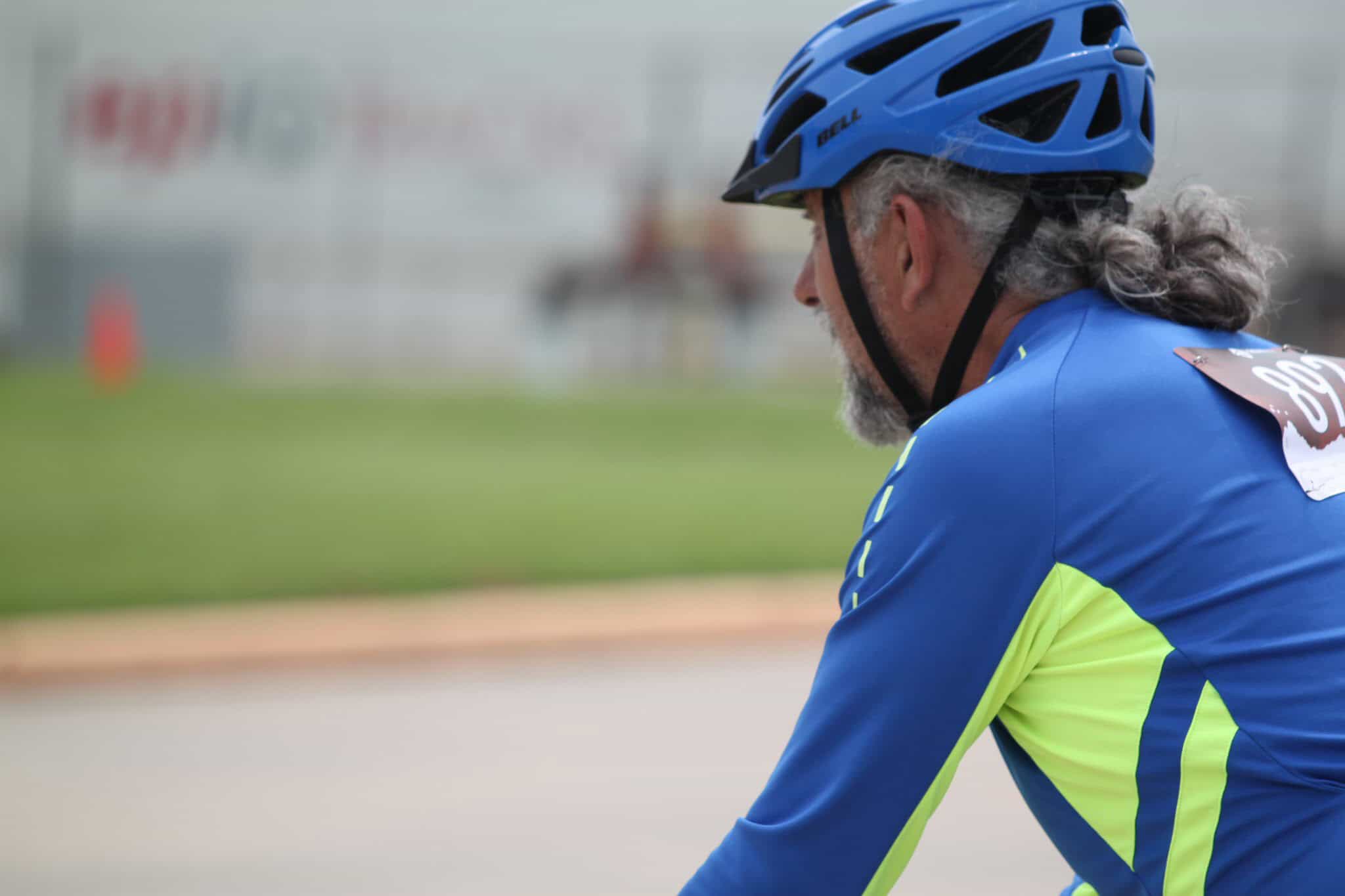 Wearing a blue helmet and cycling jersey, experienced cyclist participates in Bluebonnet Express event.