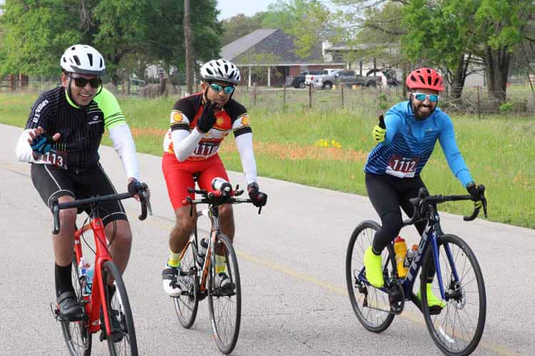 Healthy cyclists riding on scenic trail during daytime.