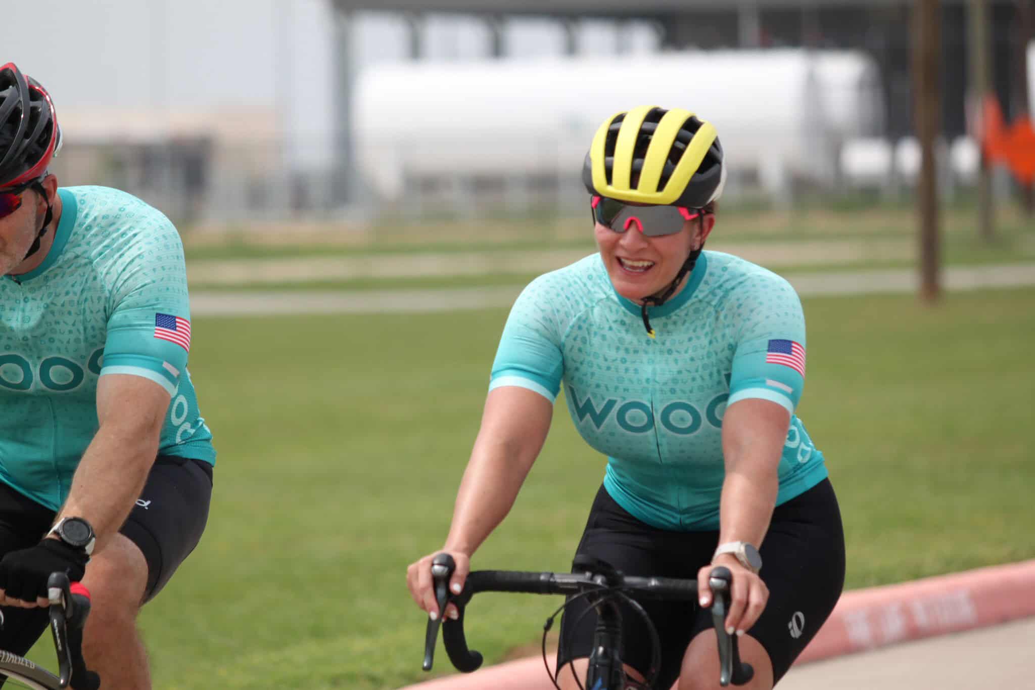 Cycling team wearing blue jerseys and helmets at Bluebonnet Express event.