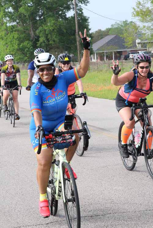 Bright cheerful cyclist enjoying the Bluebonnet Express ride, promoting community cycling events.