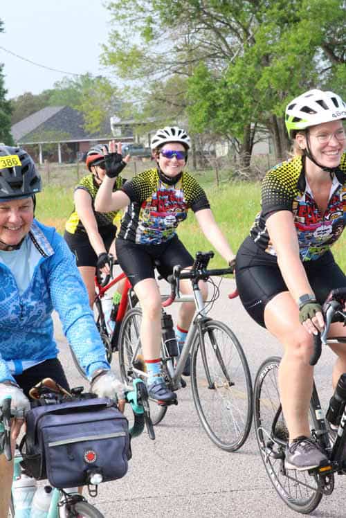 Enjoying group cycling along scenic routes during Bluebonnet Express event.
