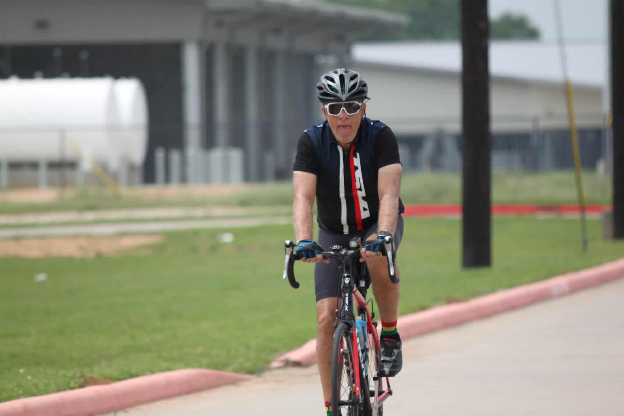 Vegan cyclist riding road bike outdoors during daytime.