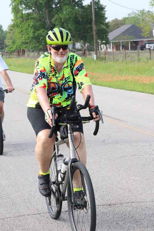 Colorful cyclist riding on a scenic bike trail in Texas during daytime.