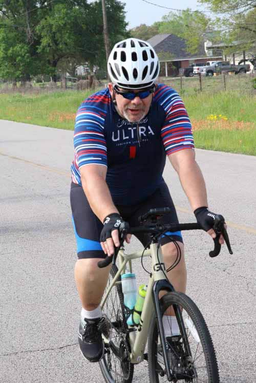 High-Performance Road Bicycle Ridden by Cyclist During Indoor Bike Ride on a Summer Day.