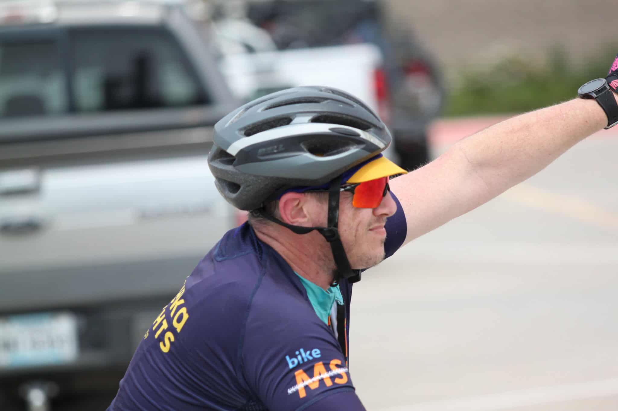 Helmet-wearing cyclist participating in Bluebonnet Express bike event, promoting cycling safety and community.