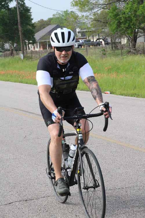 Bright-eyed cyclist enjoying a ride on a road bike during daytime.