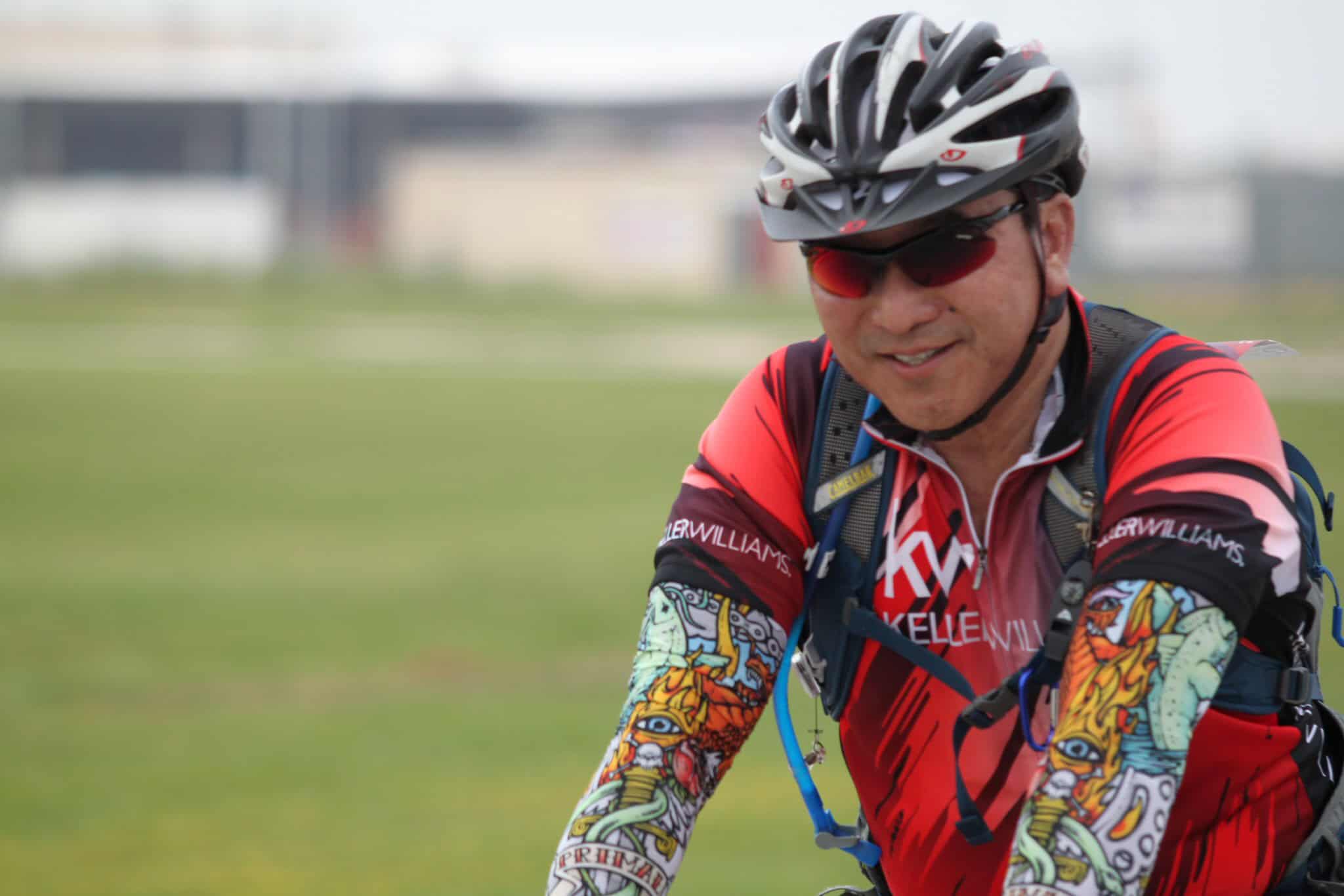 Vibrant cyclist wearing safety gear, riding outdoors for health and adventure.