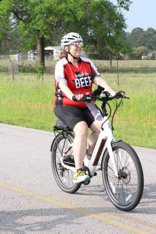 Efficient electric bike riding through scenic countryside with Bluebonnet Express.