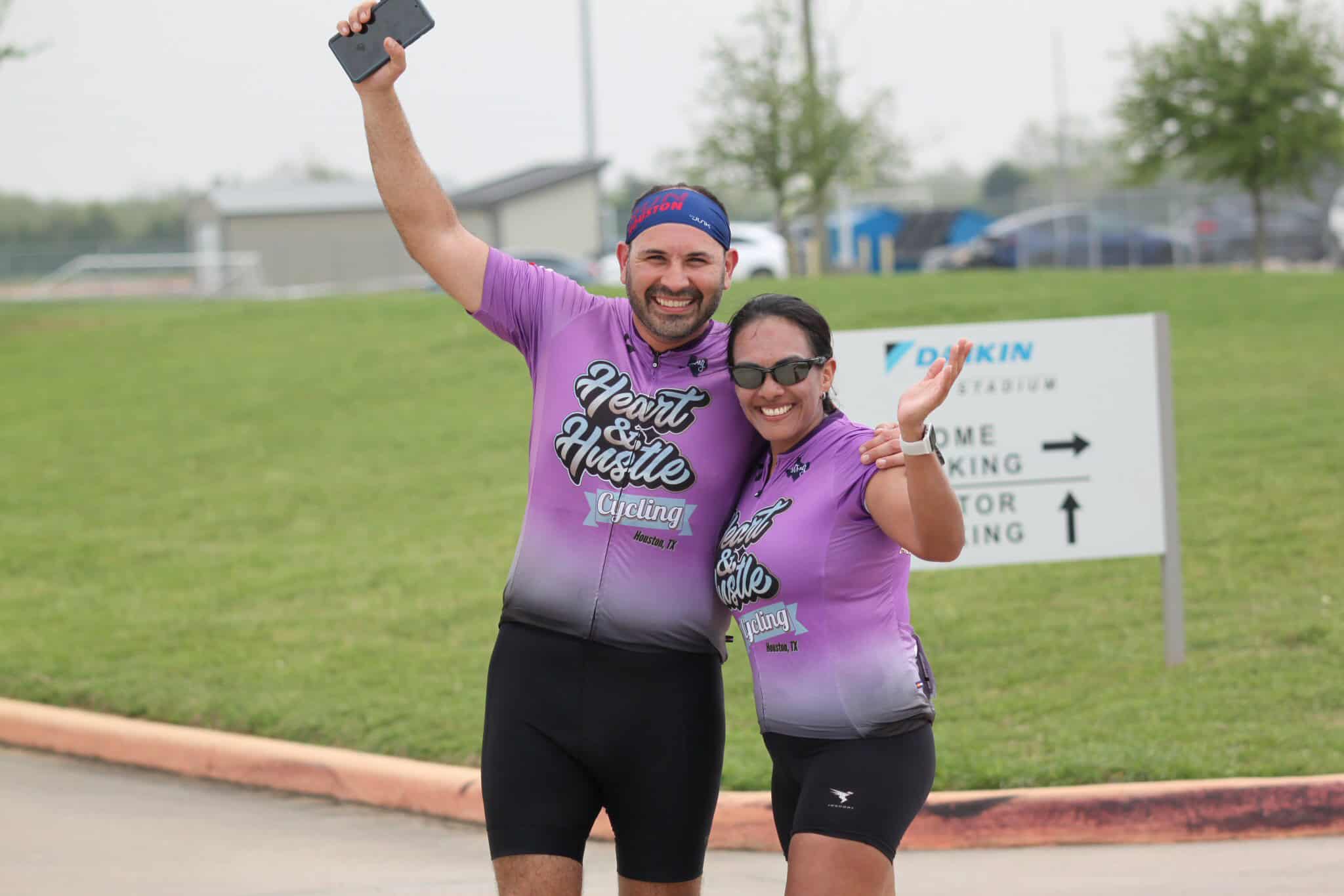 Energetic cyclists celebrating at Bluebonnet Express cycling event in Houston, TX.