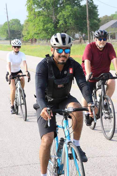 Brightly dressed cyclists enjoying a ride on a sunny day for Bluebonnet Express.