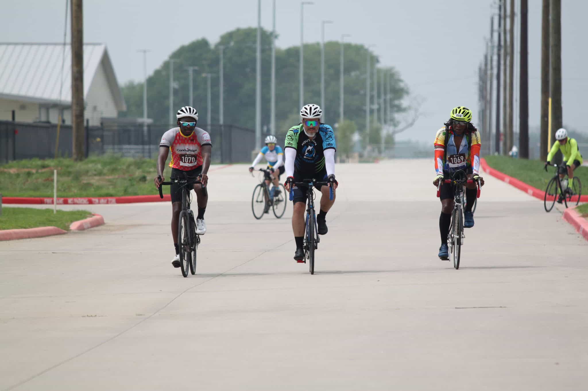 Bright cyclists participate in a Bluebonnet Express event, riding through a scenic route in Texas.