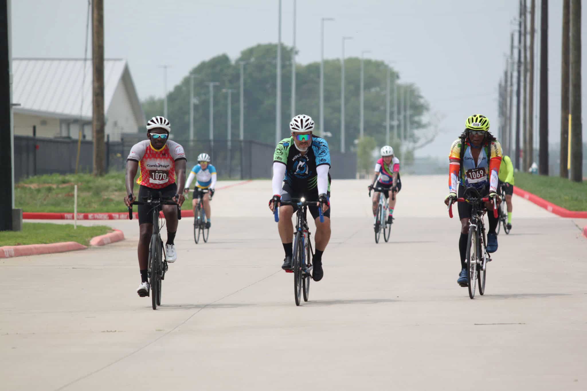 Biking group participating in Bluebonnet Express cycling event on a paved road.