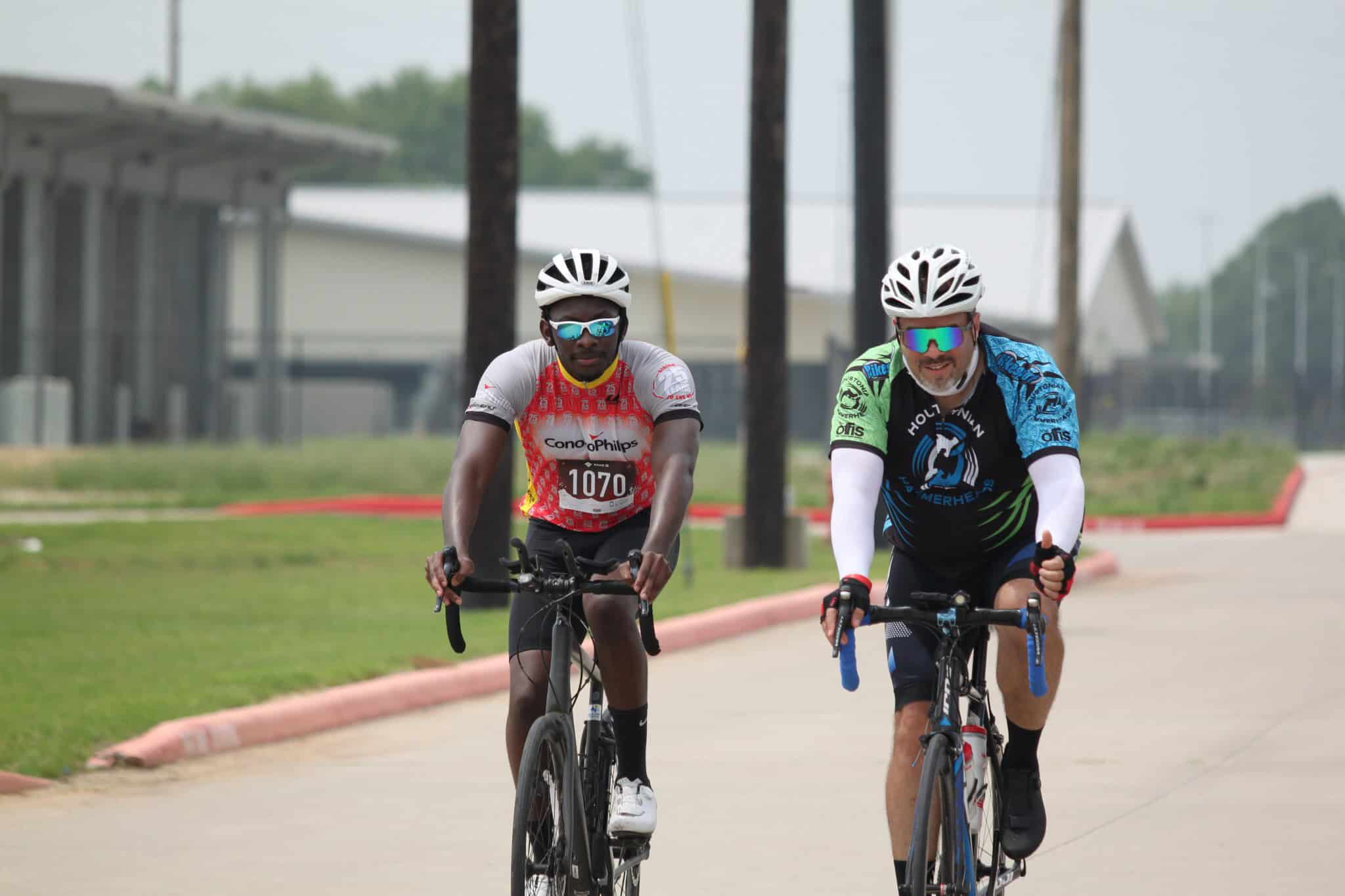 High-performance cyclists riding on a scenic bike trail, promoting Bluebonnet Express cycling event.