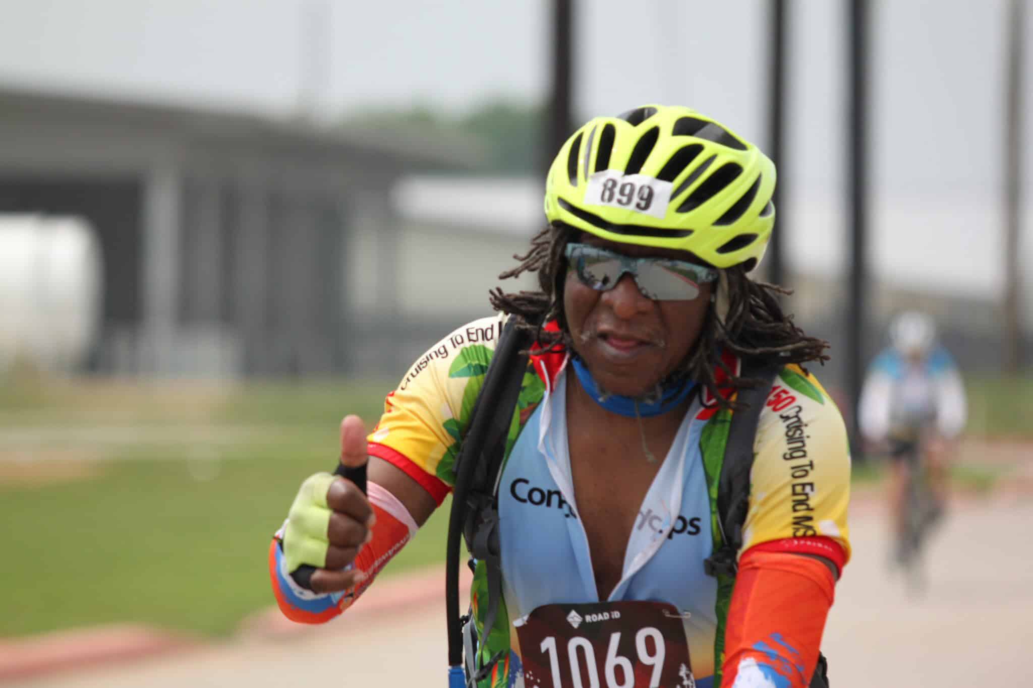 - Female cyclist with helmet and sunglasses during Bluebonnet Express bike race.