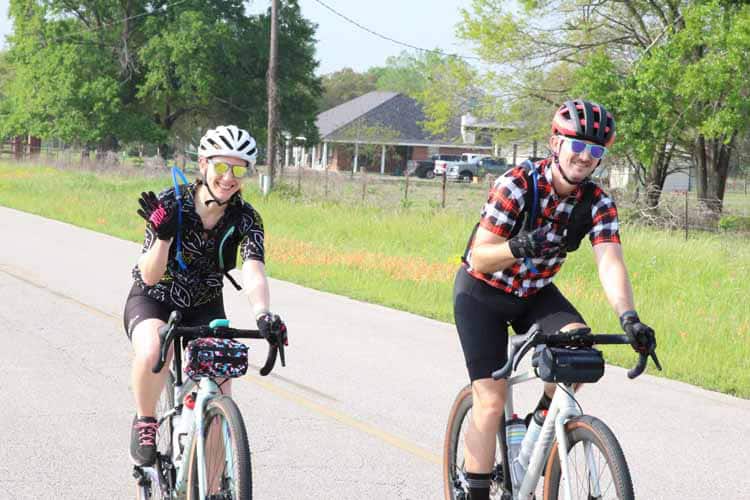 Young cyclists enjoying a scenic ride on Bluebonnet Express bike trail in Texas.