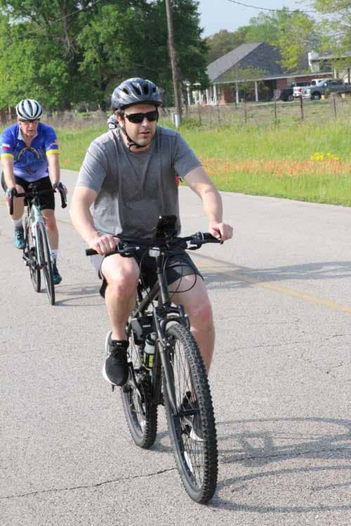 High-quality mountain biking on Bluebonnet Express trail with scenic rural background.