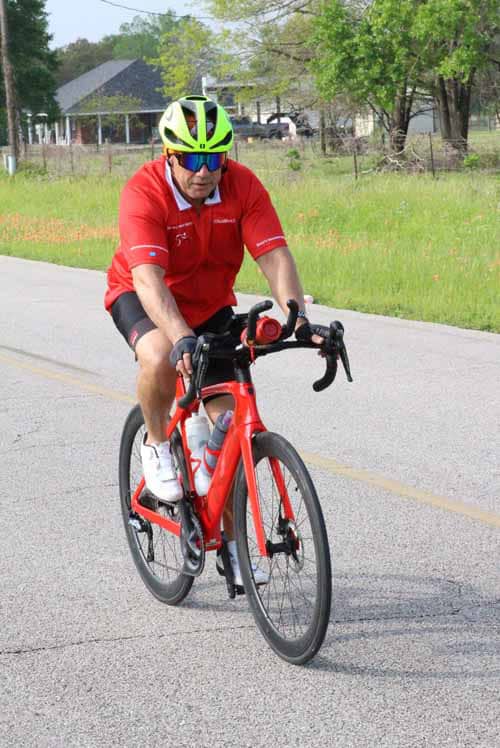 Bright yellow helmet with blue sunglasses for bike safety on Bluebonnet Express route.