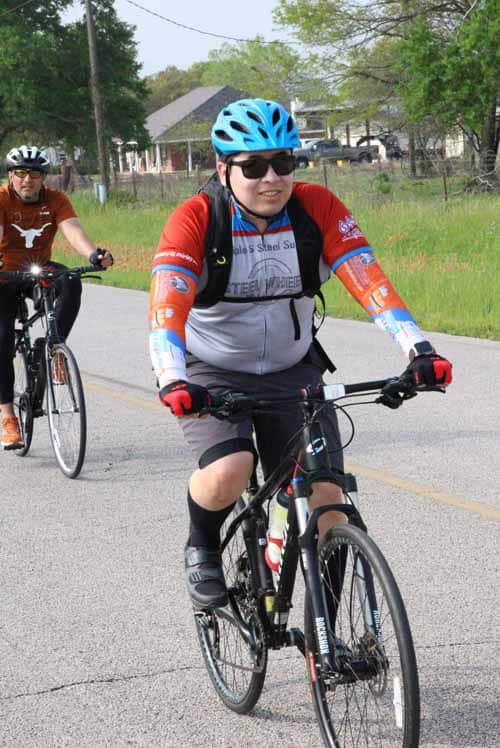Cyclist enjoying Bluebonnet Express bike ride on a scenic Texas route.