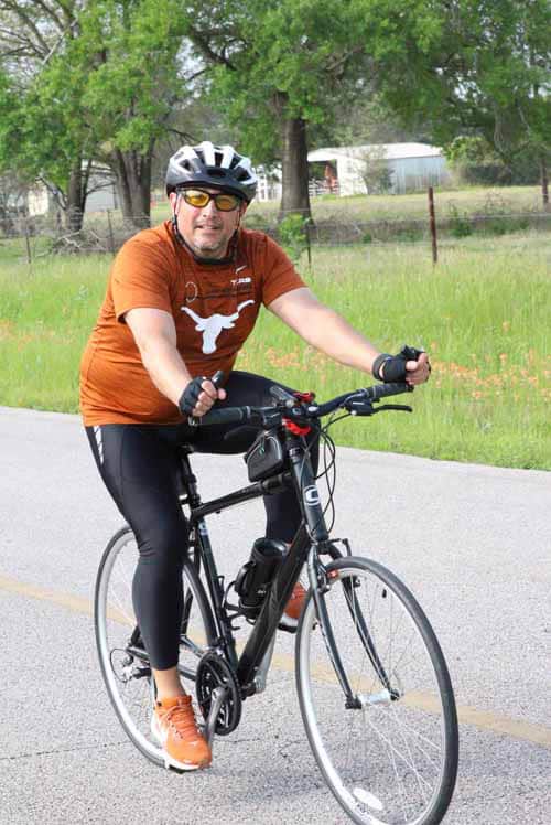 Cyclist riding an electric bike on a scenic trail in Texas, promoting eco-friendly transportation.