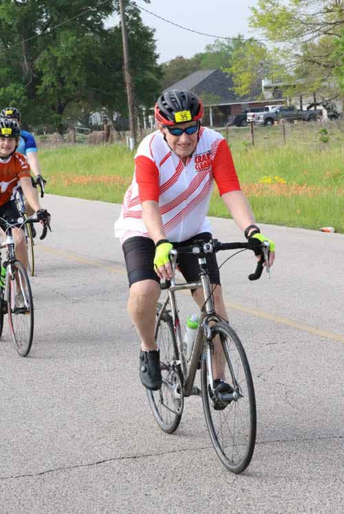 Vibrant cyclist participating in the Bluebonnet Express bike race event outdoors.