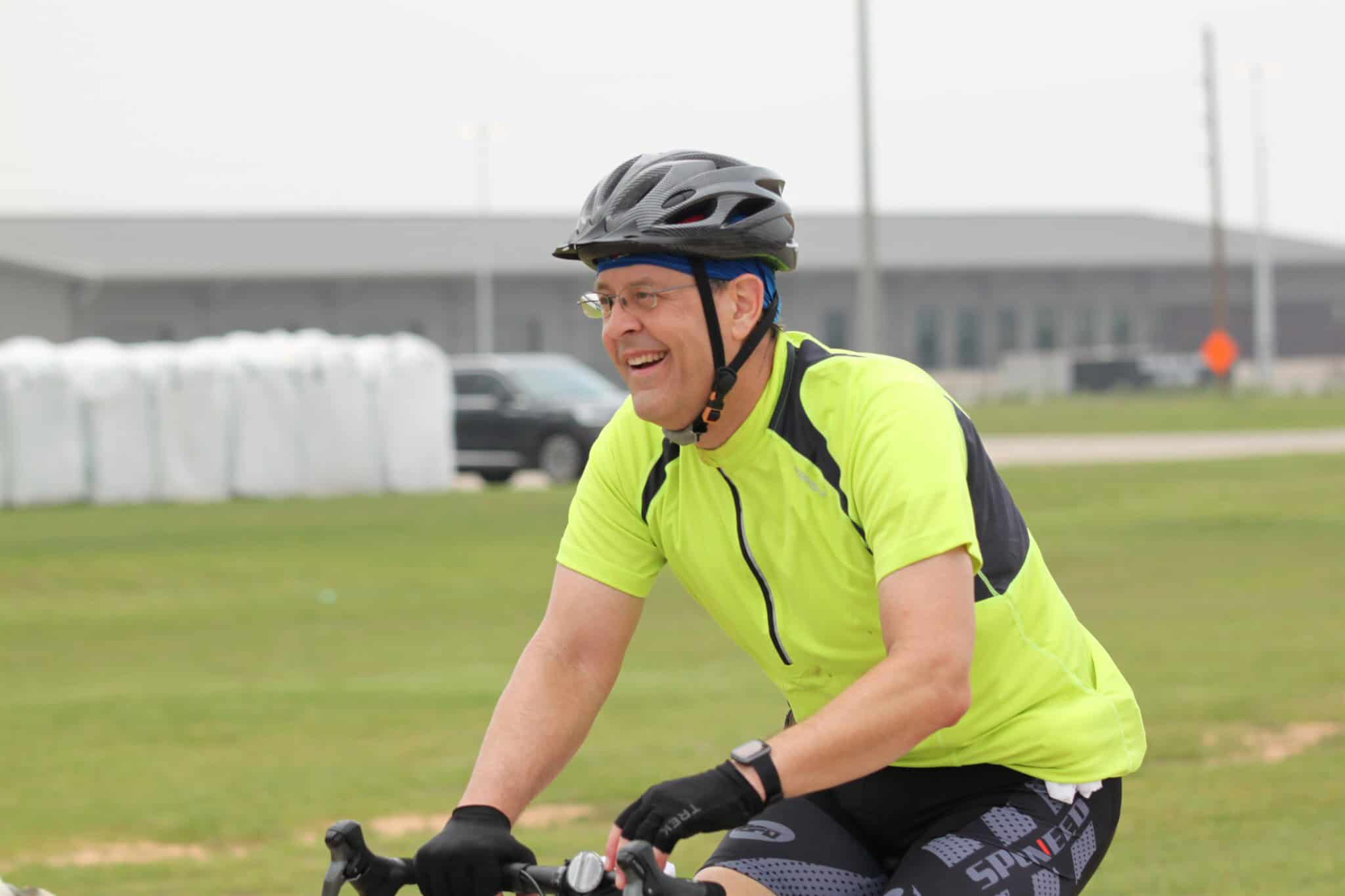 Bike rider smiling on the Bluebonnet Express cycling route, enjoying outdoor fitness.
