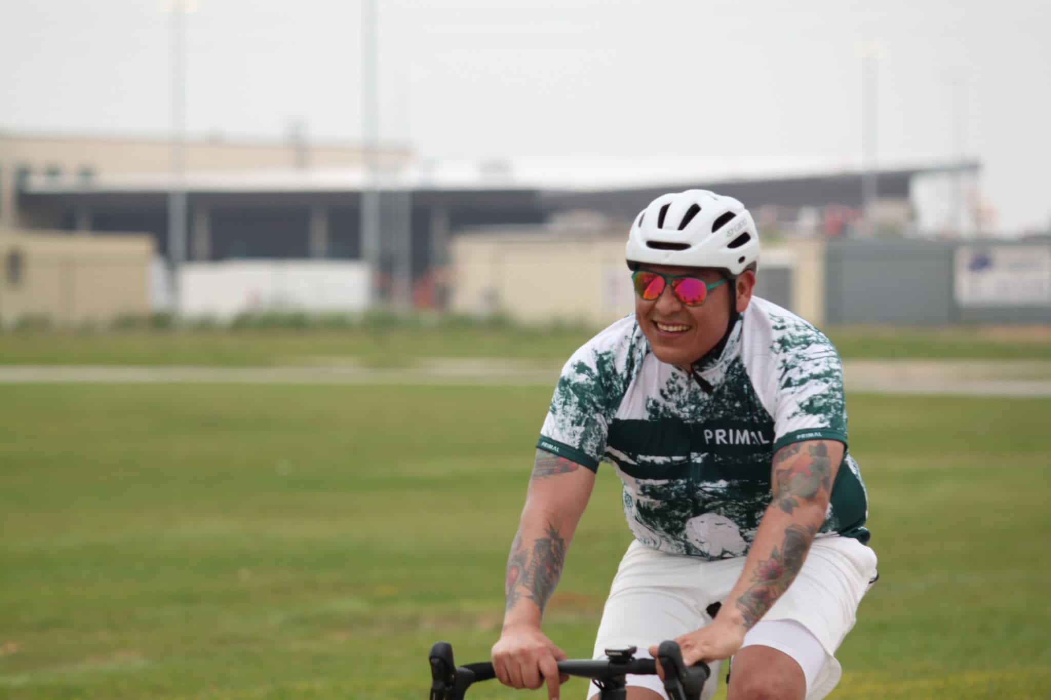 Vibrant cyclist enjoying outdoor ride on Bluebonnet Express bike trail in scenic park setting.