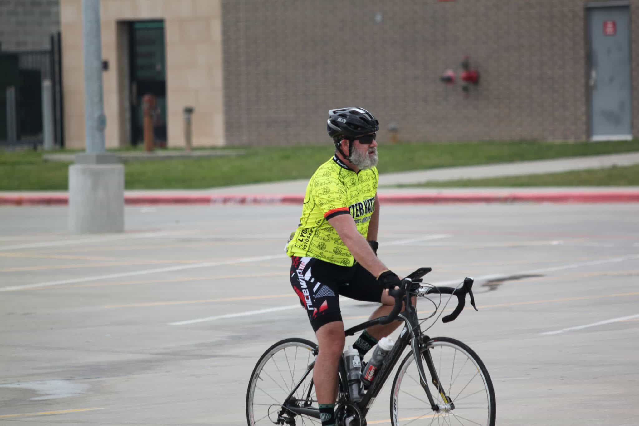 Bright yellow cyclist jersey with Bluebonnet Express logo for bike riding events and tours.