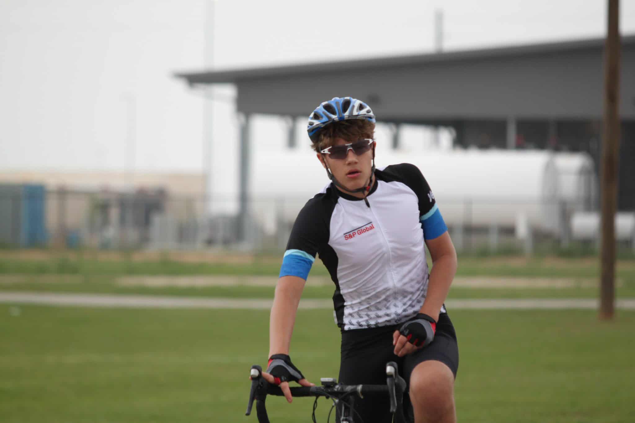 Boy cyclist wearing biking gear and helmet on a trail in Texas.
