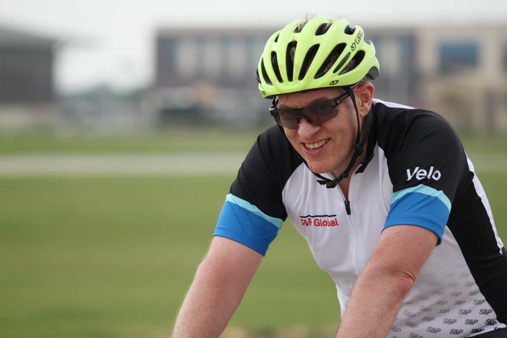 Vibrant cyclist wearing a lime green helmet and sunglasses during a Bluebonnet Express bike ride.