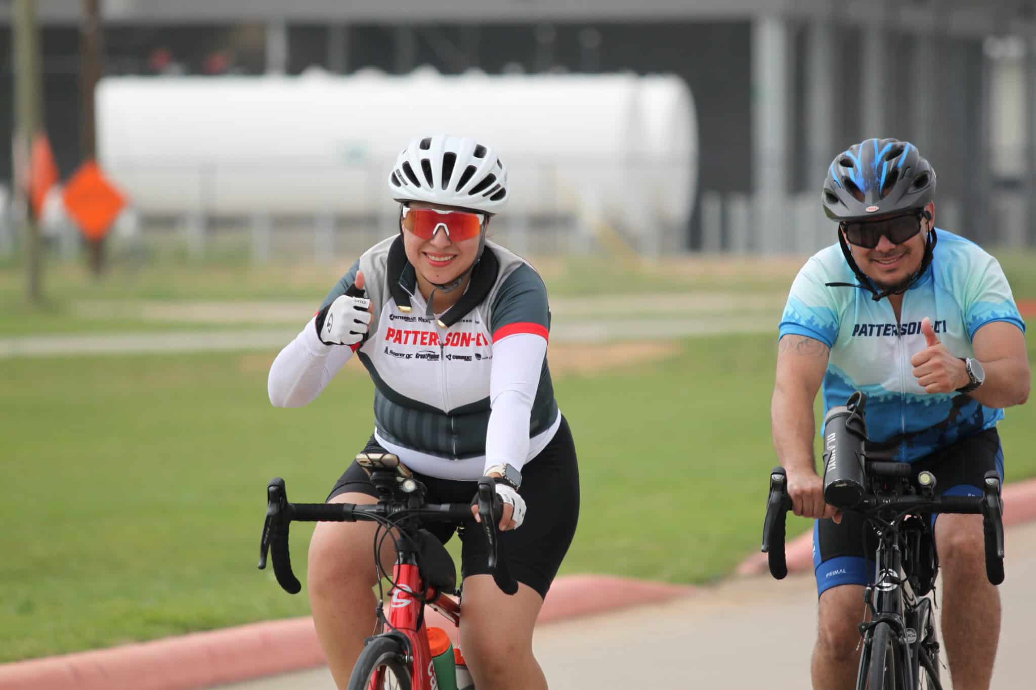 Smiling cyclists enjoying a ride on the Bluebonnet Express bike trail, promoting outdoor fitness and cycling adventures.