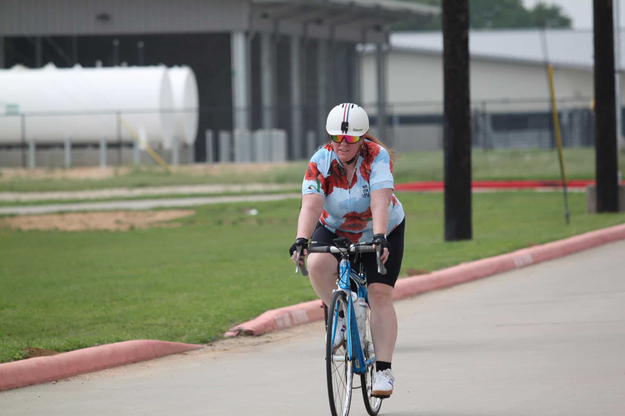 Efficient cyclist riding on the road with safety gear during the Bluebonnet Express bike event.