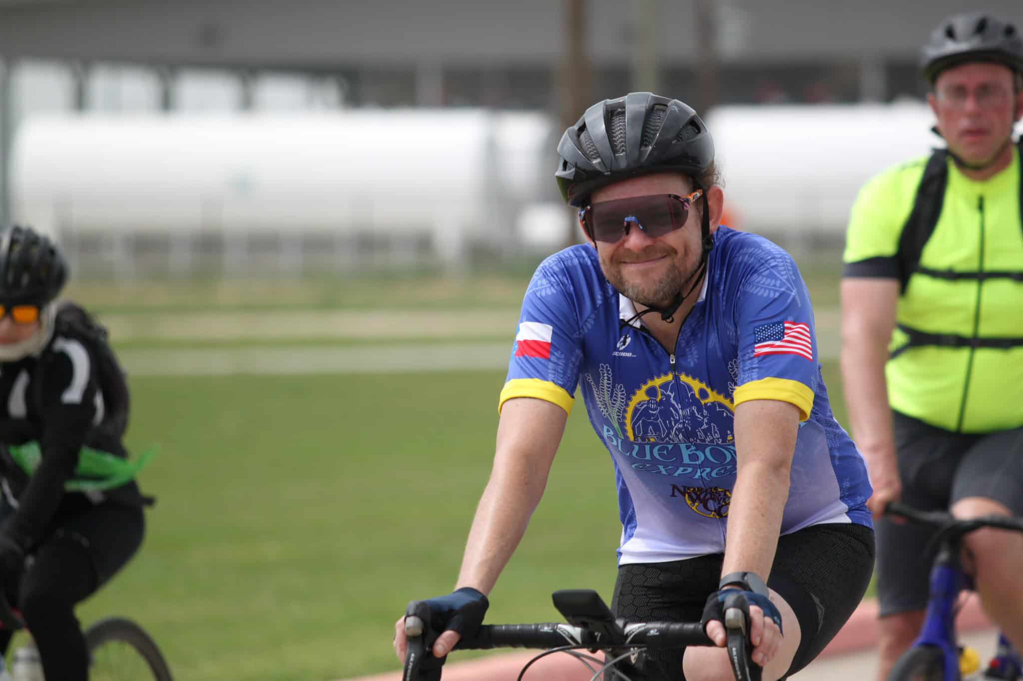 Riders participating in Bluebonnet Express cycling event, wearing helmets and sports gear.