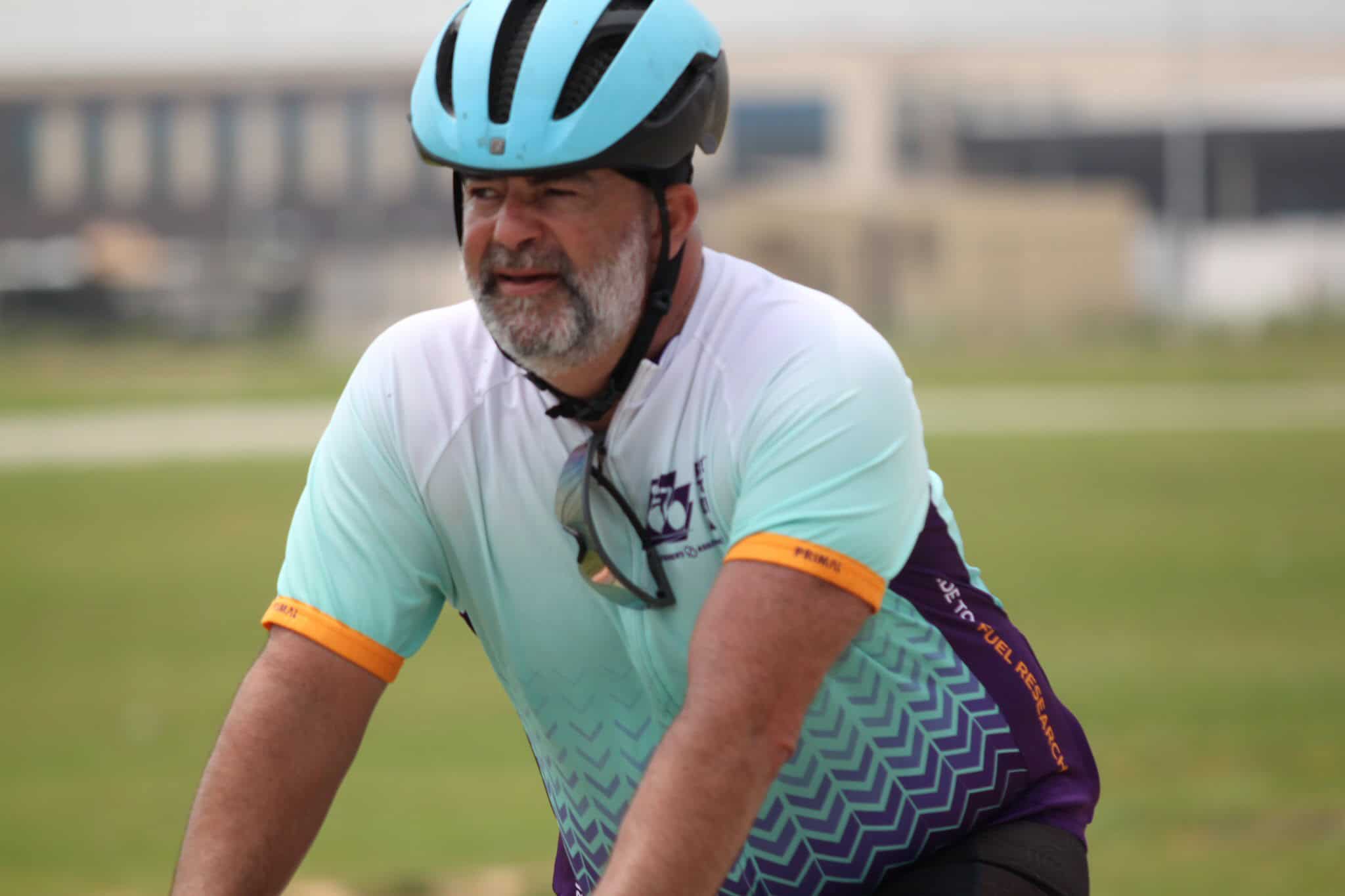 1. Male cyclist in helmet riding Bluebonnet Express bike on a grassy trail.