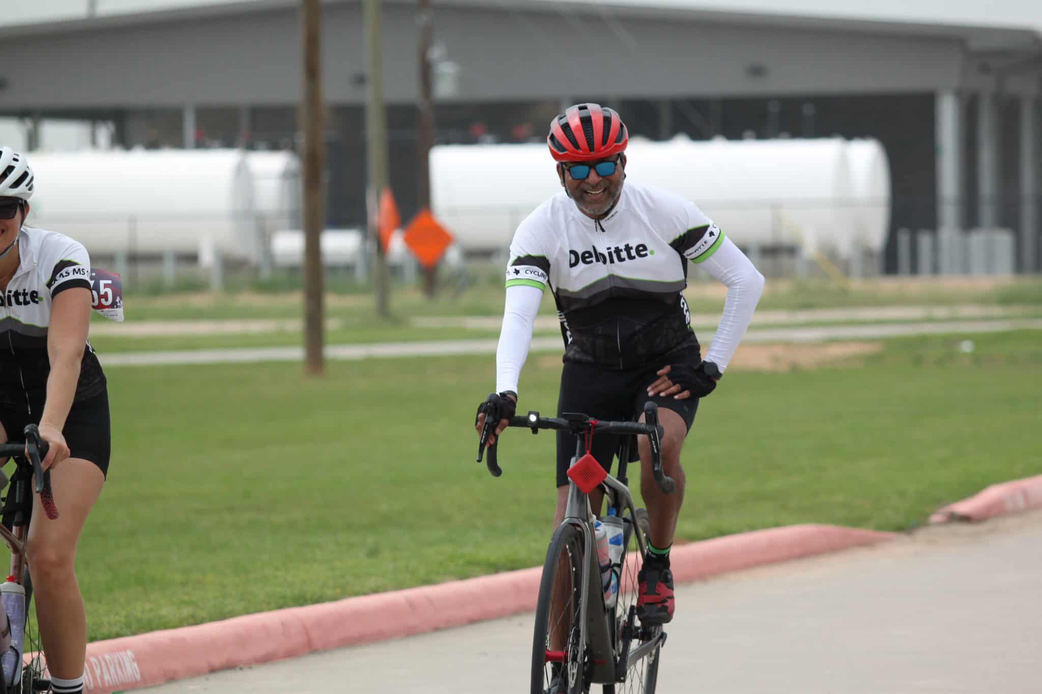 Cyclist wearing Delaware team jersey riding during Bluebonnet Express event, promoting active lifestyle and cycling.