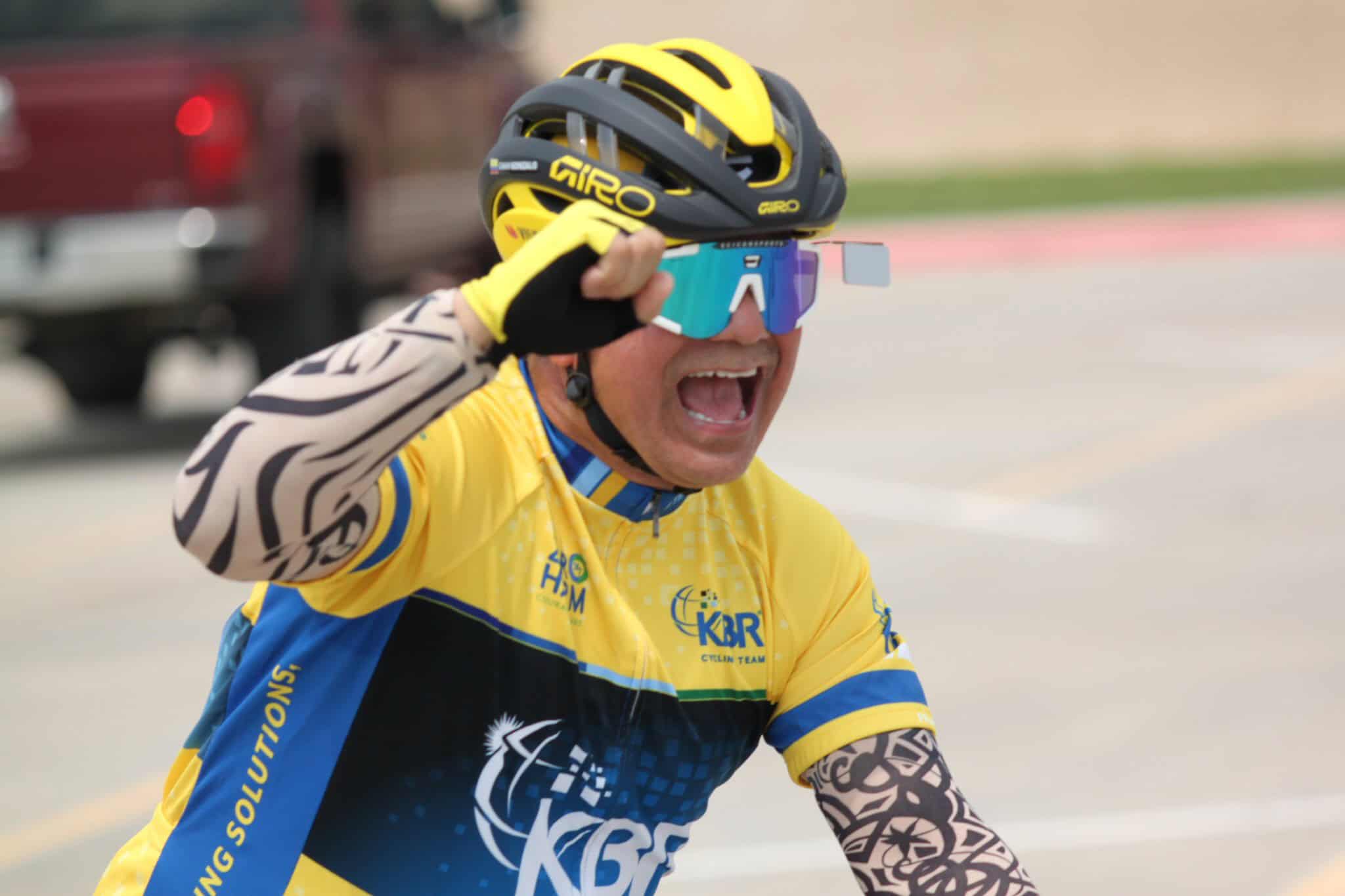 Bright yellow cyclist helmet and glasses, expressive celebration at Bluebonnet Express race event.