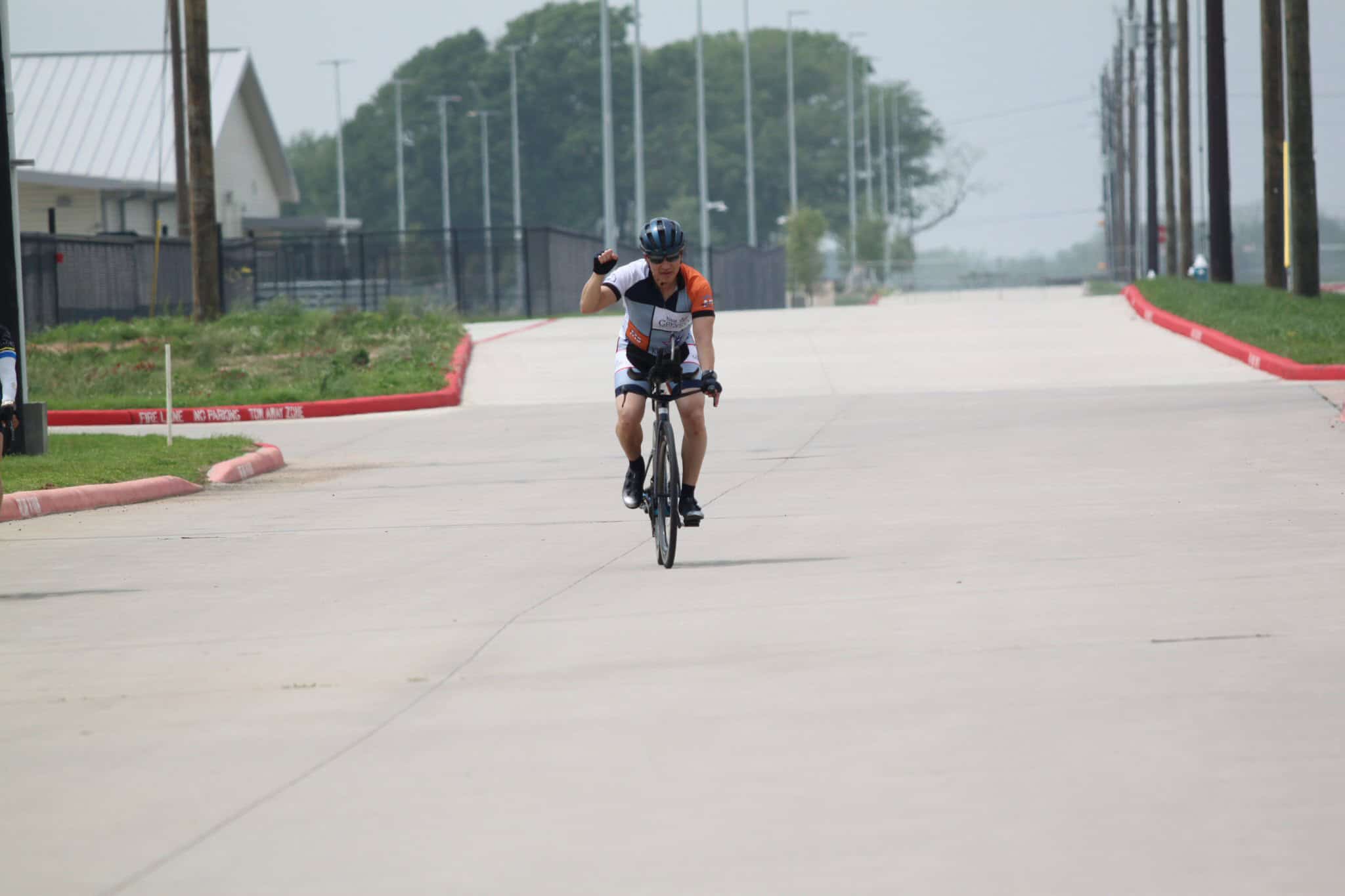 Rider celebrating victory on a solo cycling race at Bluebonnet Express event.