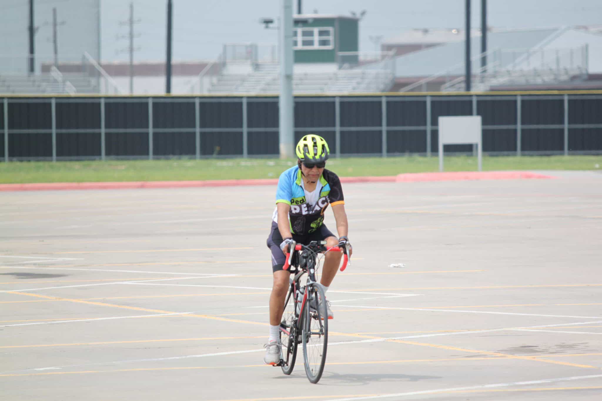 Cyclist riding in empty parking lot during Bluebonnet Express event.