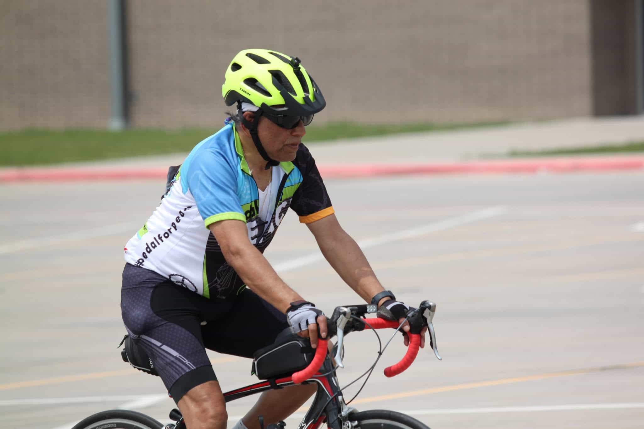 High-performance cyclist wearing helmet and cycling gear riding during Bluebonnet Express event.