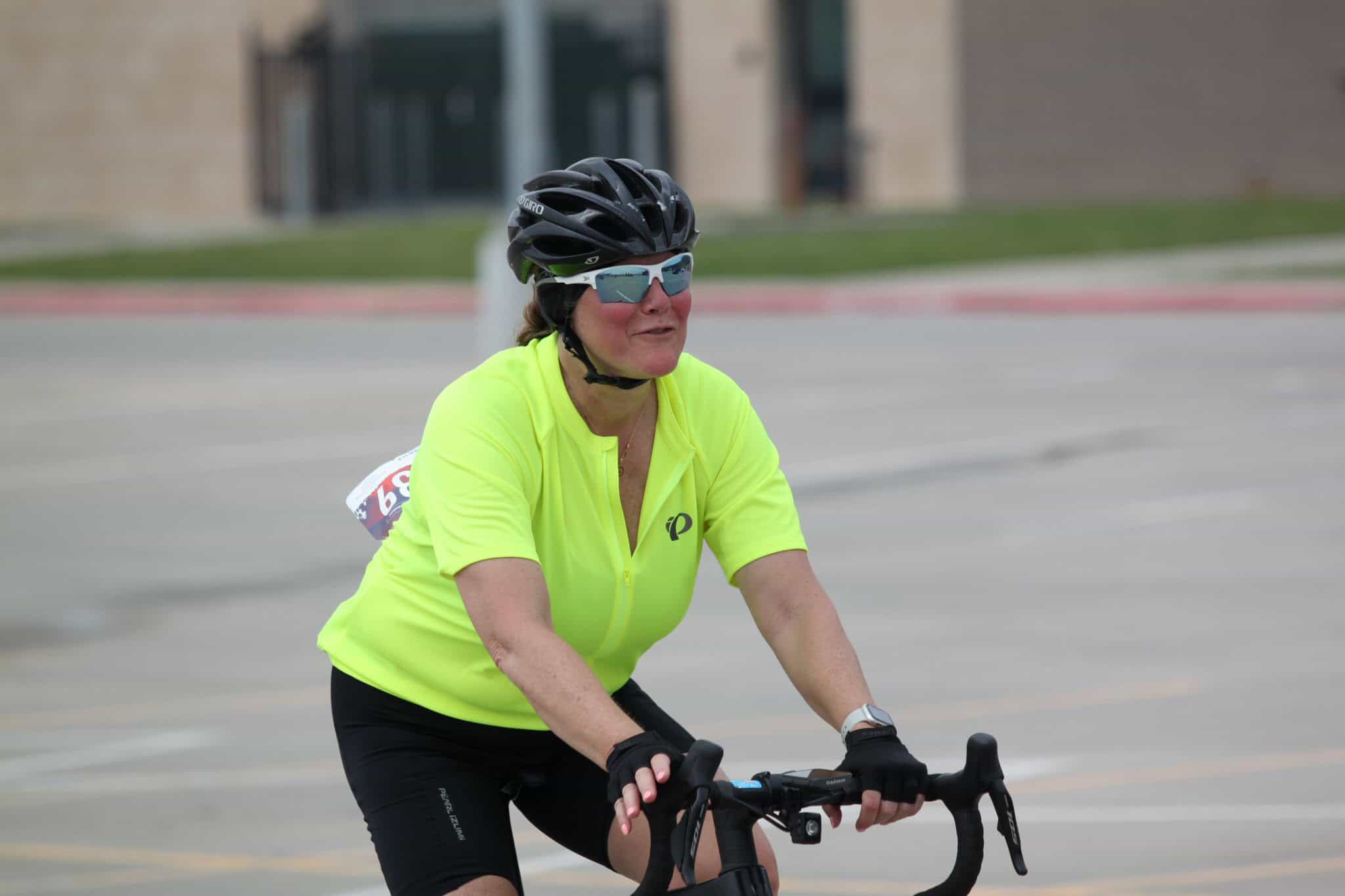 Bright yellow cycling jersey worn by female cyclist on Bluebonnet Express ride in Texas.
