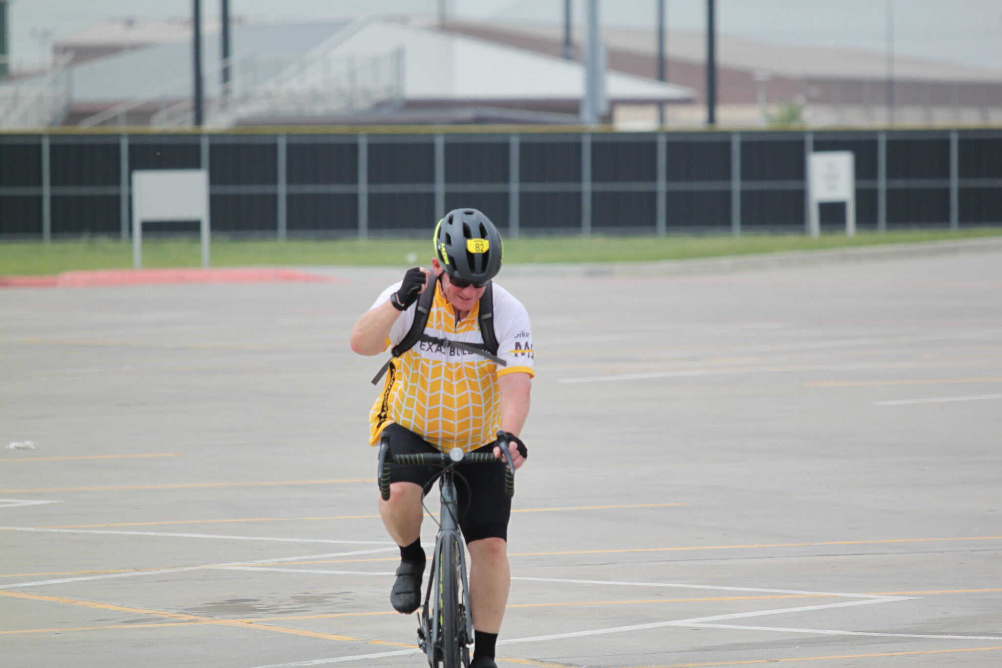 Bike delivery rider on an empty parking lot at Bluebonnet Express.