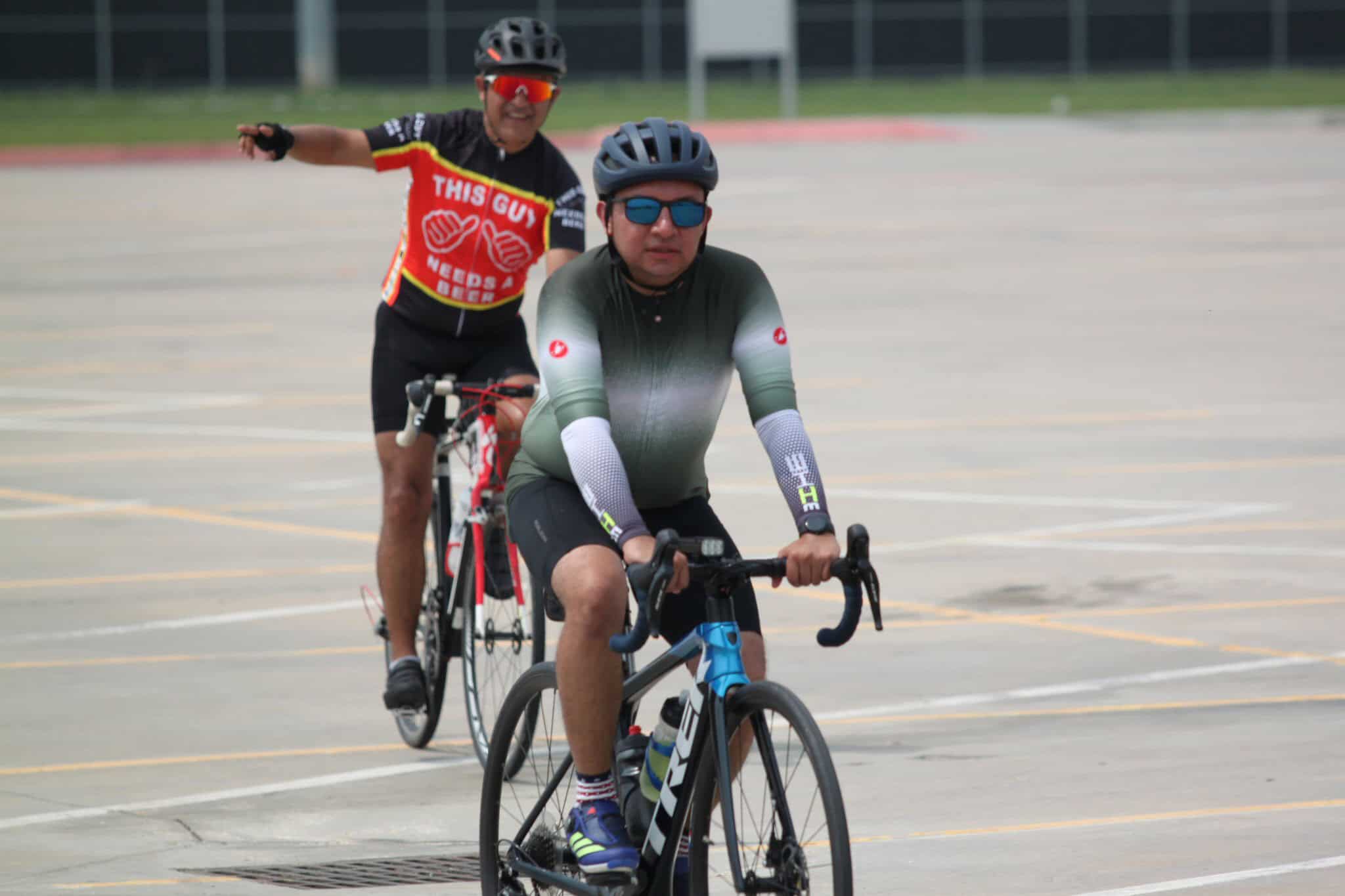 Cyclists riding on a road during a cycling event, emphasizing bike race and outdoor activity.