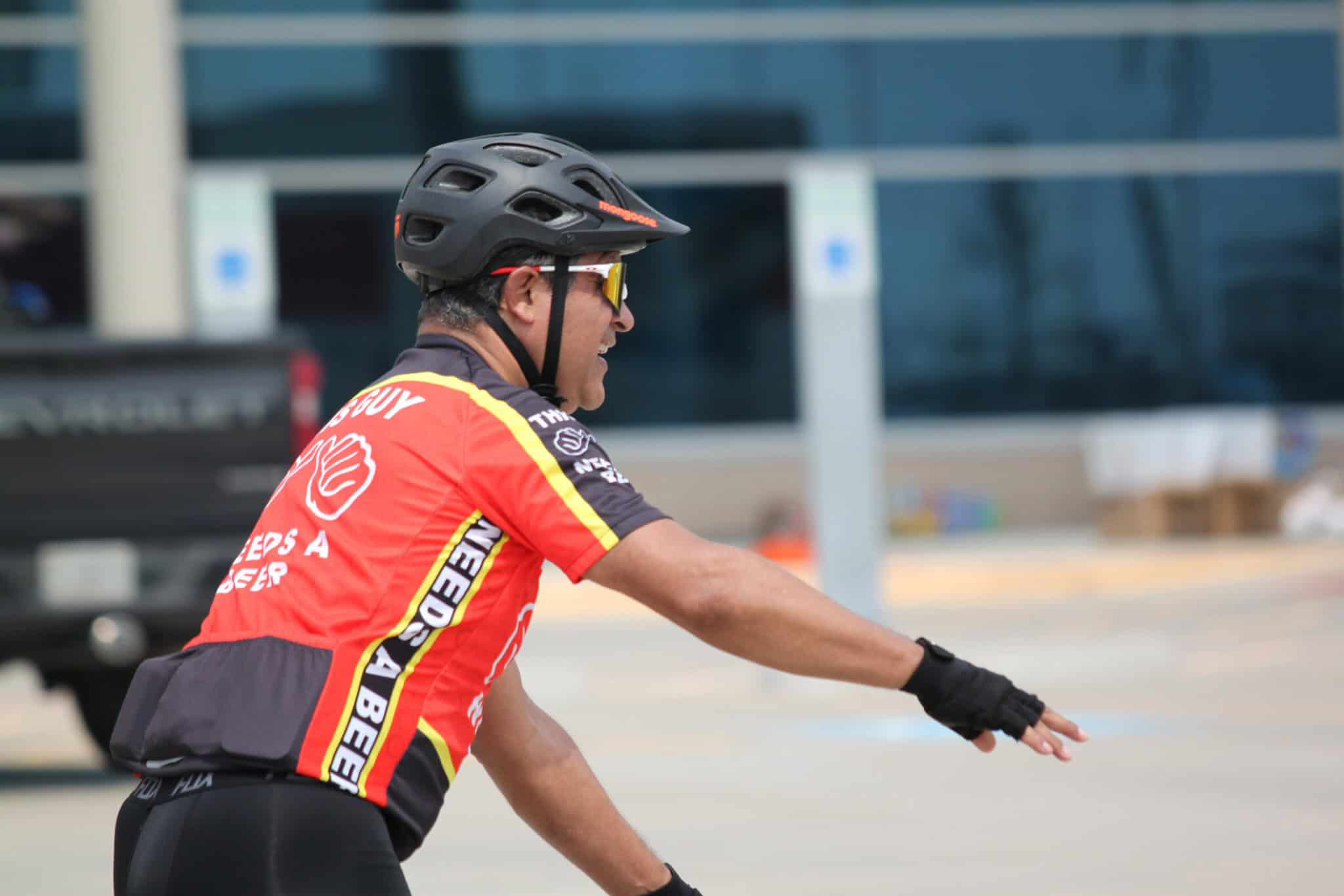Bike rider wearing a helmet and sports jersey, promoting Bluebonnet Express cycling service.