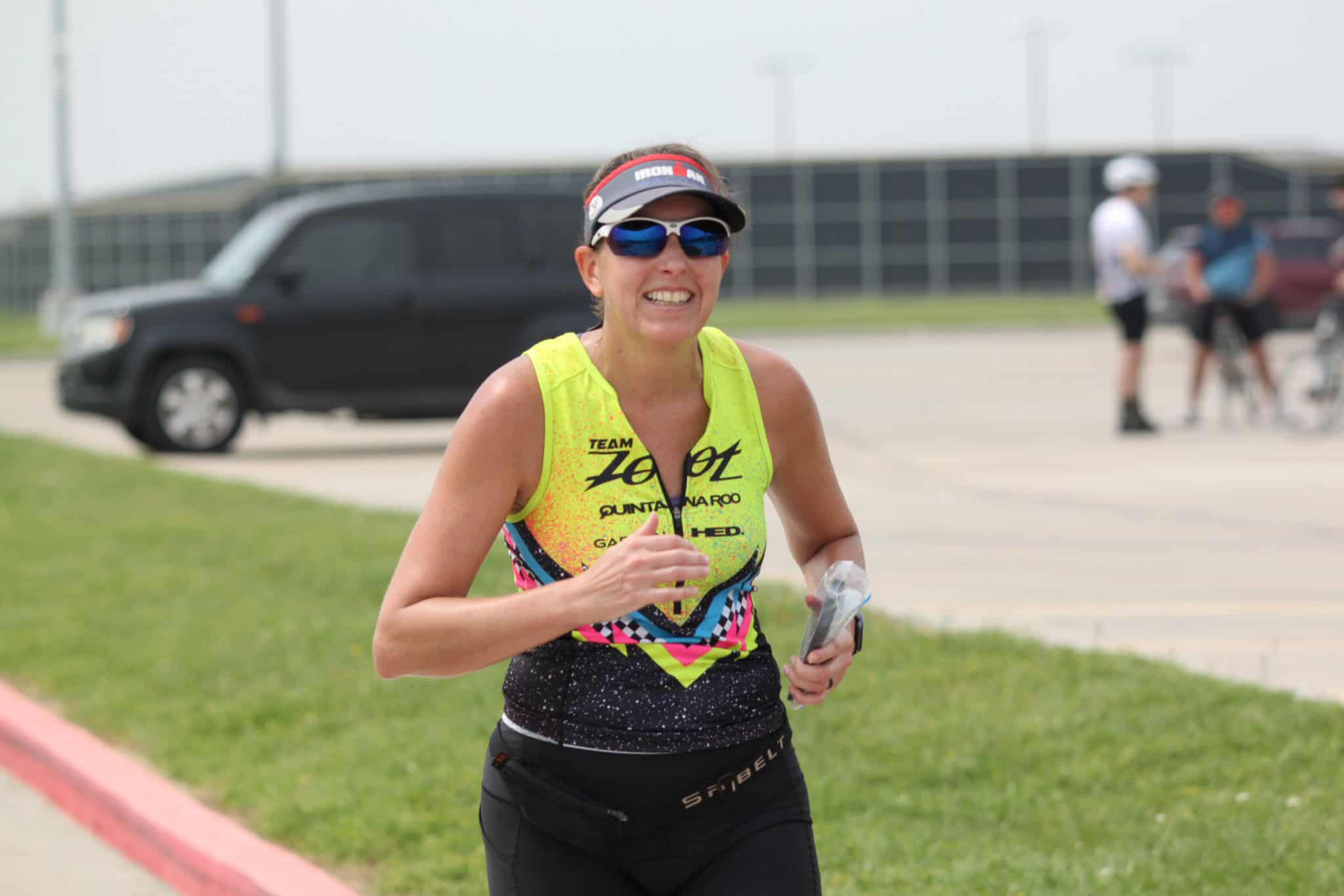 Bright yellow triathlon race jersey, athlete smiling during Bluebonnet Express event, outdoor sports competition.