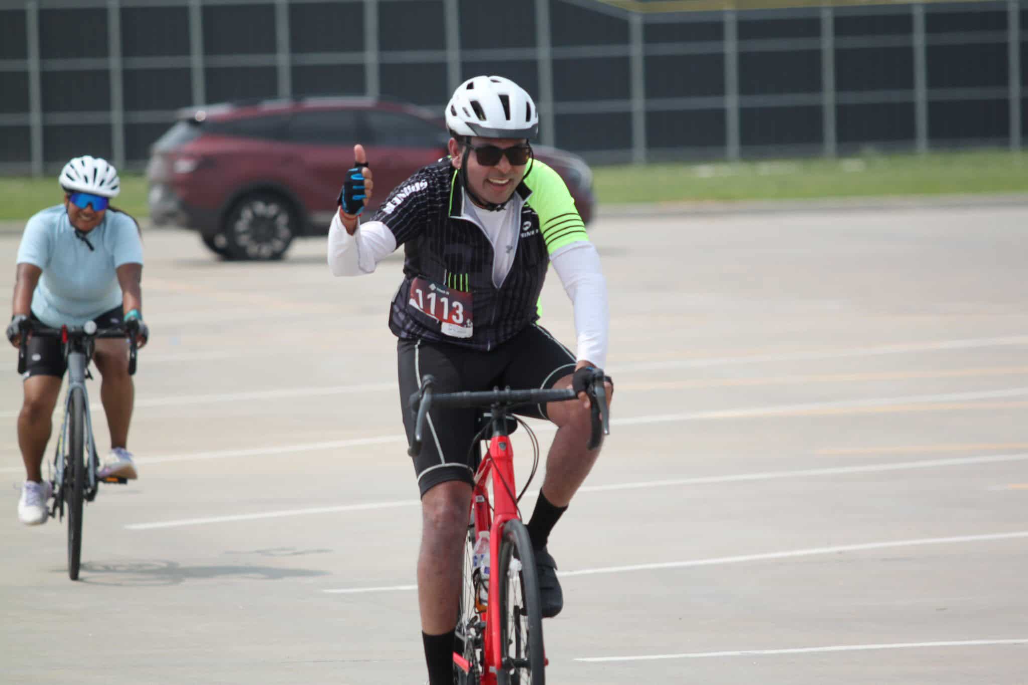 Active cyclist giving thumbs-up during Bluebonnet Express bike race event.