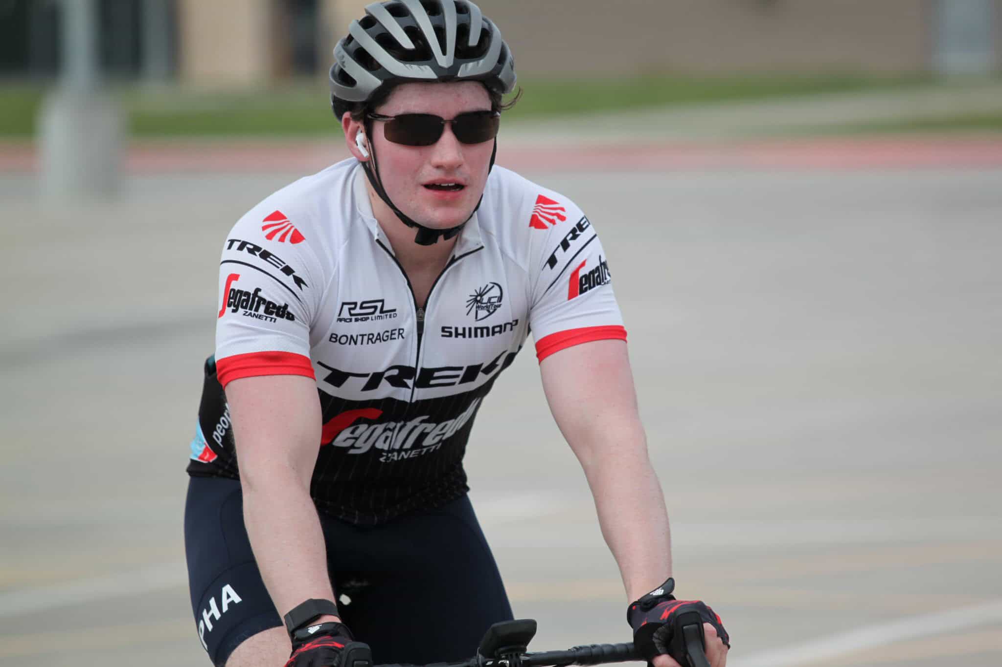 High-performance cyclist riding on the road wearing Trek and Egafeds team gear.