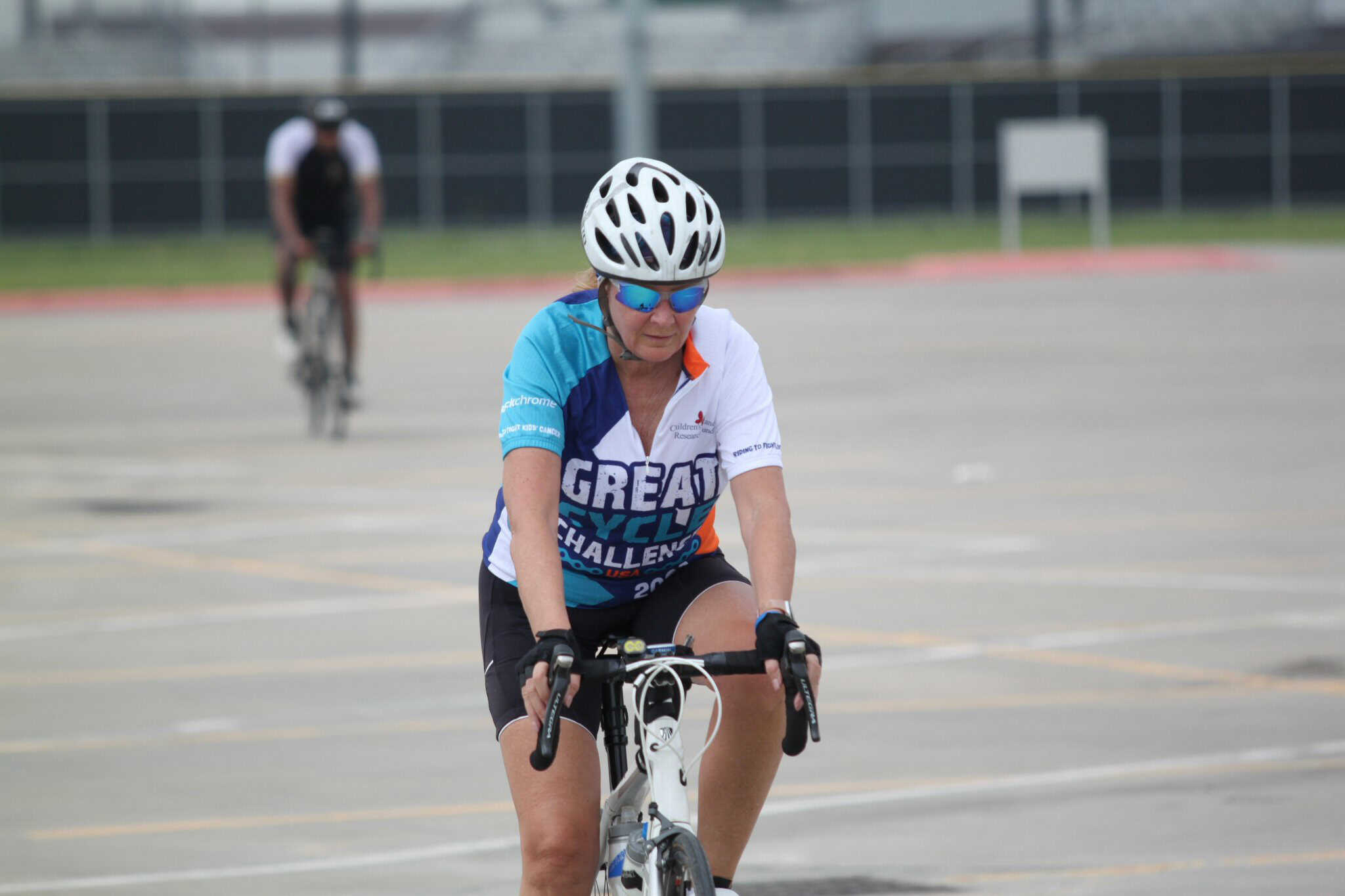Cyclist wearing a helmet and sunglasses participating in Bluebonnet Express bike ride.
