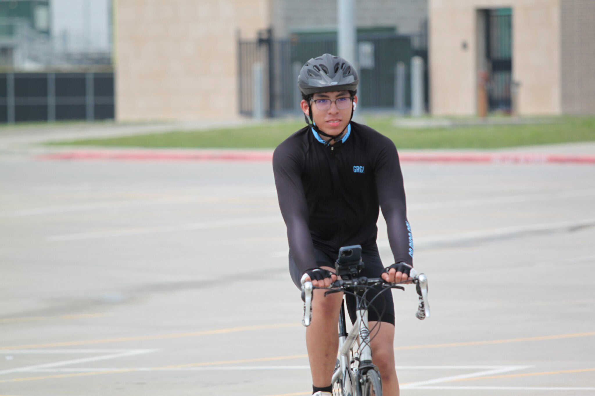 Helmeted cyclist riding on city street during daytime with Bluebonnet Express branding.